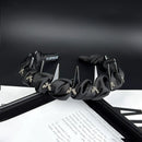 Close-up of hand-finished crystal bow detail on black satin hair band