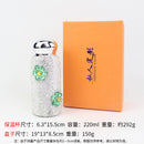 Close-up of floral pattern and crystal accents on green tumbler surface