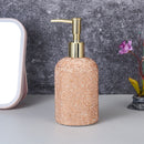 Close-up of champagne gold dispenser pump mechanism and matte finish texture