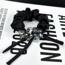 Close-up of square-cut crystal detail on satin ribbon bow