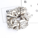 White cashew print scrunchie laid flat showing texture and stitching