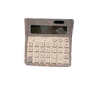 Calculator in natural office setting with documents and pen