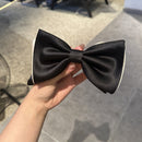 Hair clip positioned at the crown of a model's head with soft waves