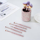 Top-down layout showing all 9 brushes neatly arranged in white fabric storage case