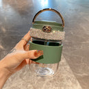 Tumbler next to potted succulent and open journal