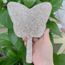 Minimalist bedroom setting featuring mirror on nightstand with linen bedding