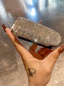 Hand holding open mirror comb demonstrating ease of use