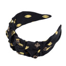 Flat lay of both black and emerald green headbands on neutral linen