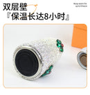 Tumbler held against blurred holiday backdrop — festive gifting scene