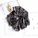 Black cashew print satin scrunchie wrapped around wrist