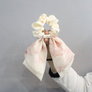 Double-tone oil painting bow hair tie in green on white background front view