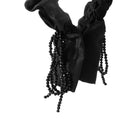 Flat lay of headband with subtle shadow, emphasizing minimalist shape and finish