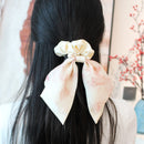 Close-up of hand-stitched bow seam and smooth fabric band texture