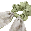 Black bow hair tie tied in a high ponytail with voluminous blowout