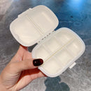 Open pill box revealing three-section compartments for morning, afternoon, evening doses