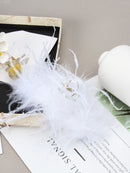 Packaging shot: SUUMEE matte box with tissue-wrapped feather clip