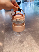 Minimalist shelf display featuring both pink and green tumblers